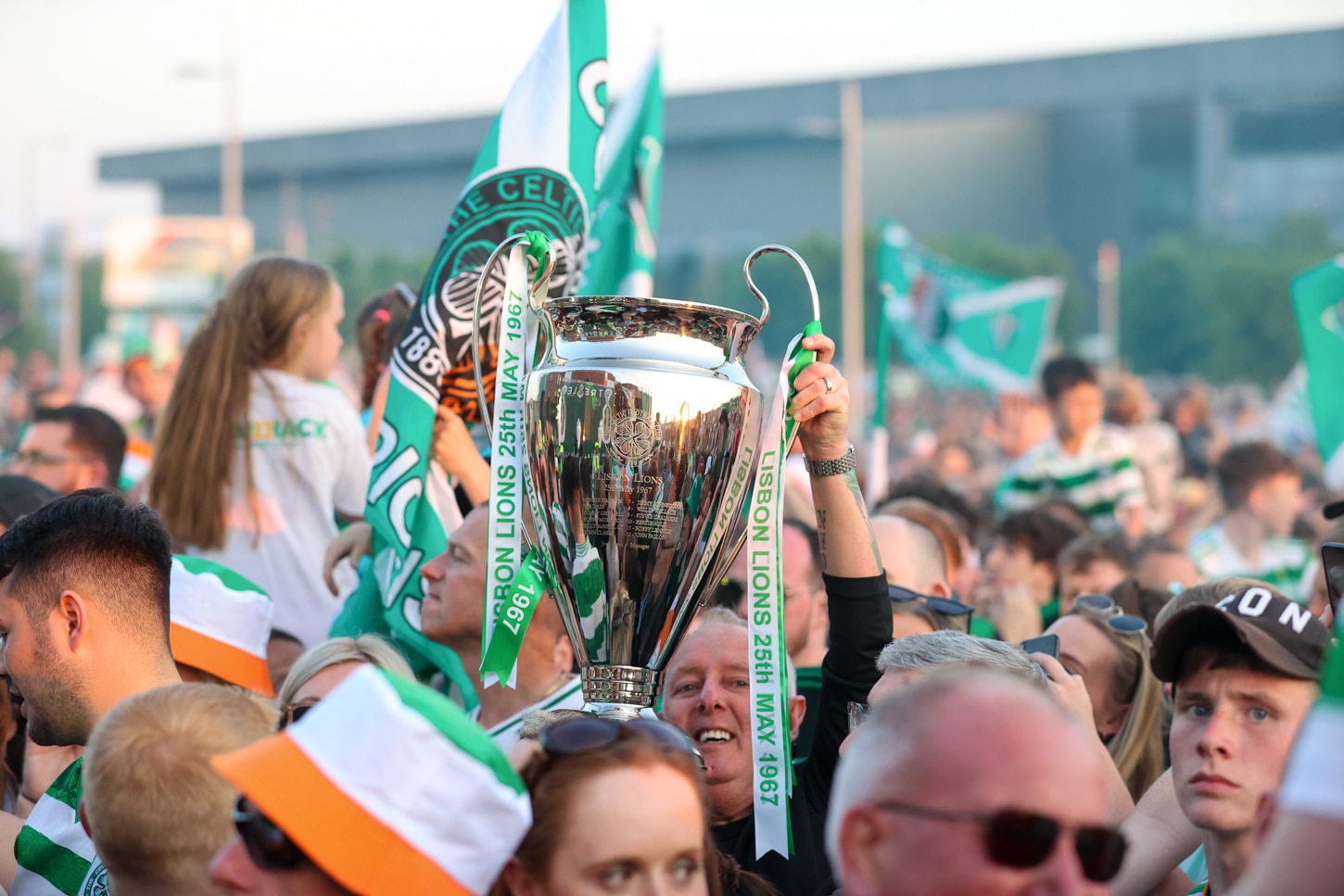 Celtic fans in Rotterdam: Full matchday guide to Feyenoord 3 Celtic fans in Rotterdam | We could see similar scenes like: a Celtic fan holding up a UEFA Champions League replica trophy