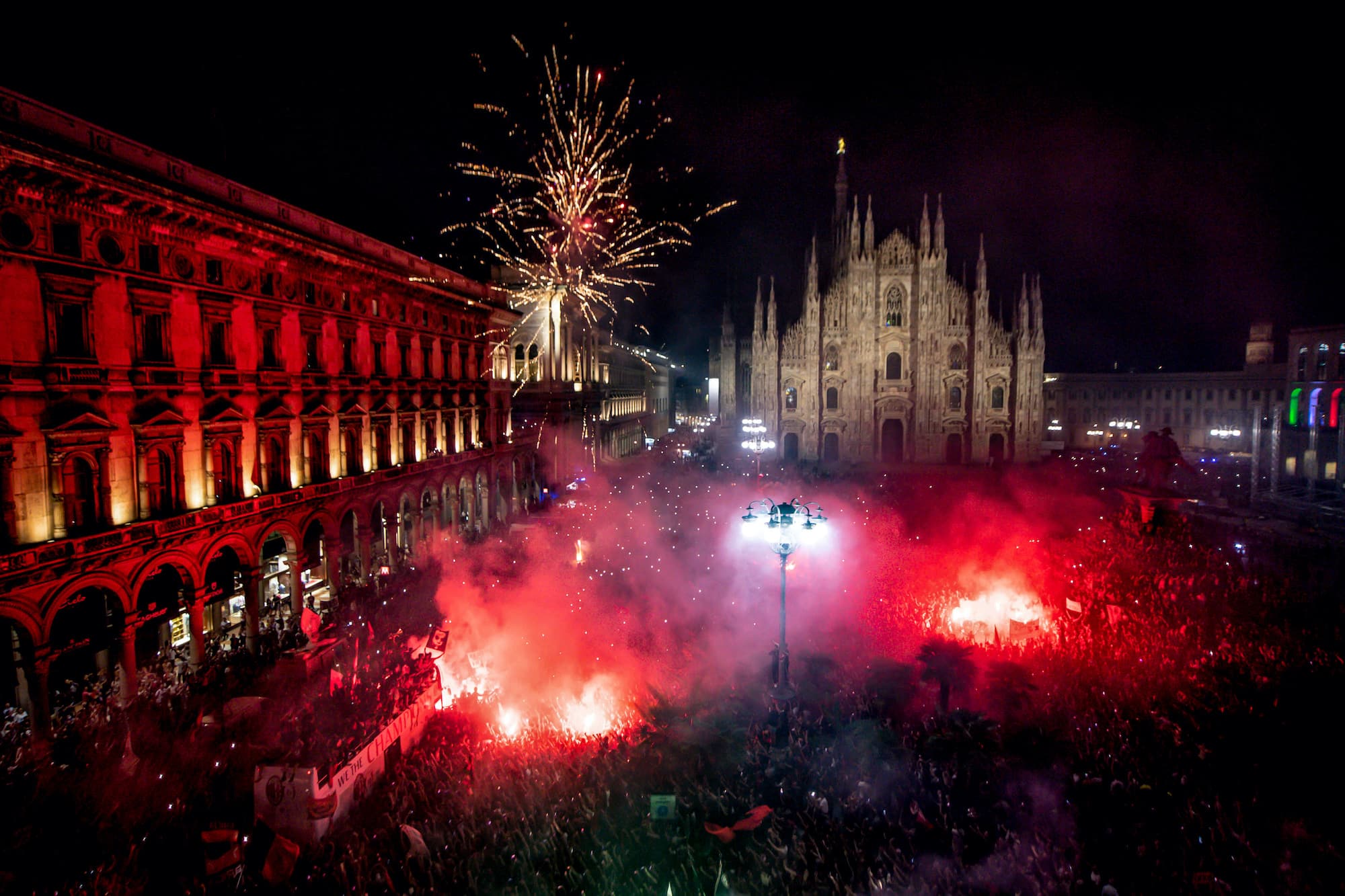 Milan Cathedral with AC Milan fans celebrating their league title in 2022 | San Siro away section - Newcastle fans guide to Milan away
