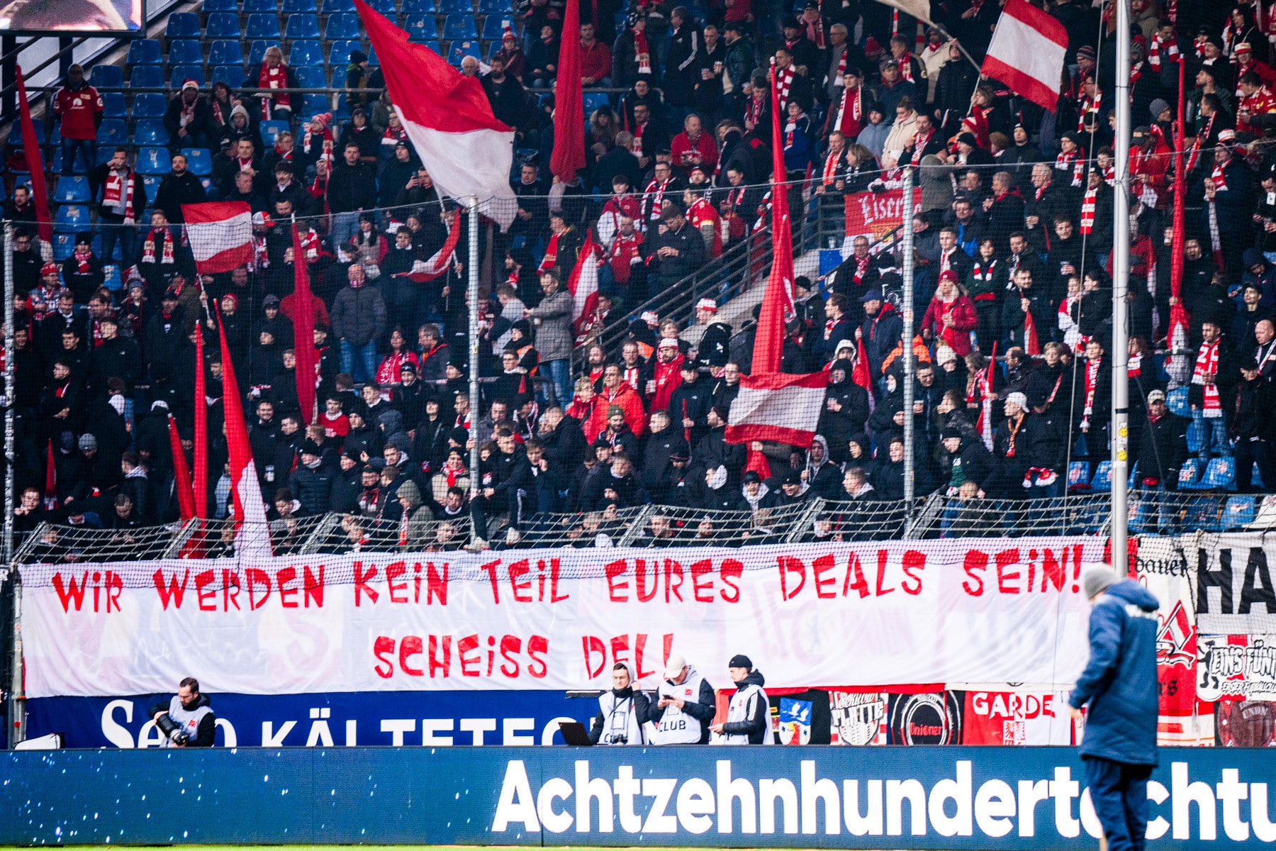 What's behind major German football and Bundesliga protests? 1 Supporters hold up a banner saying "Wir werden kein teil eures deals sein scheiss DFL" | Bundesliga protests, German football protests