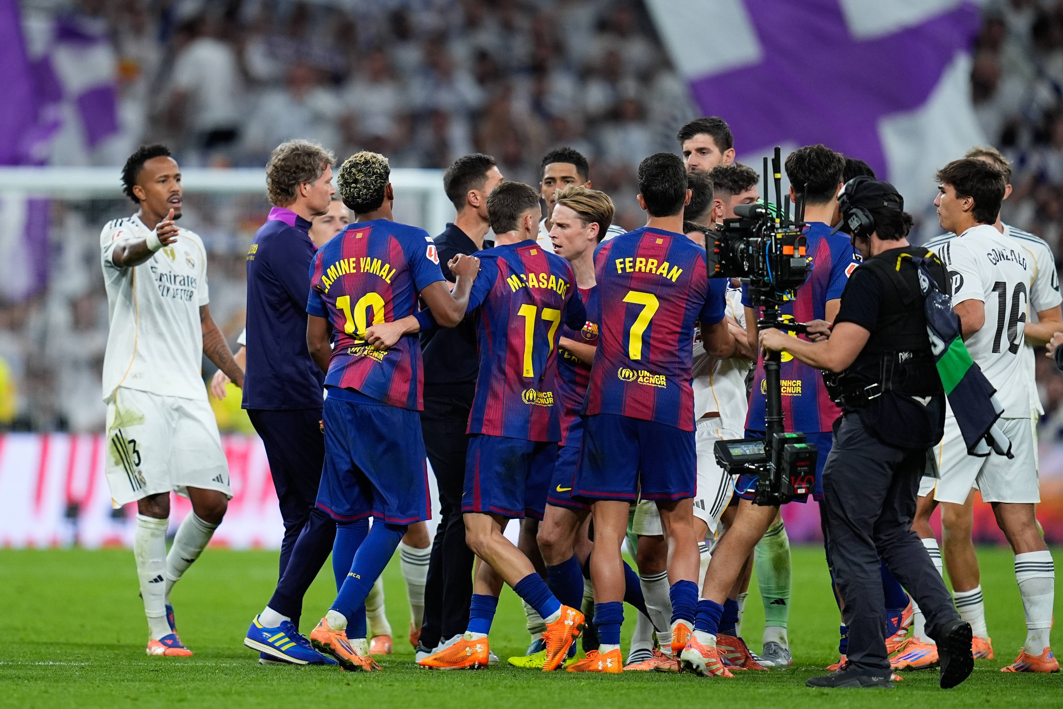 Barcelona and Real Madrid players clash during El Clasico