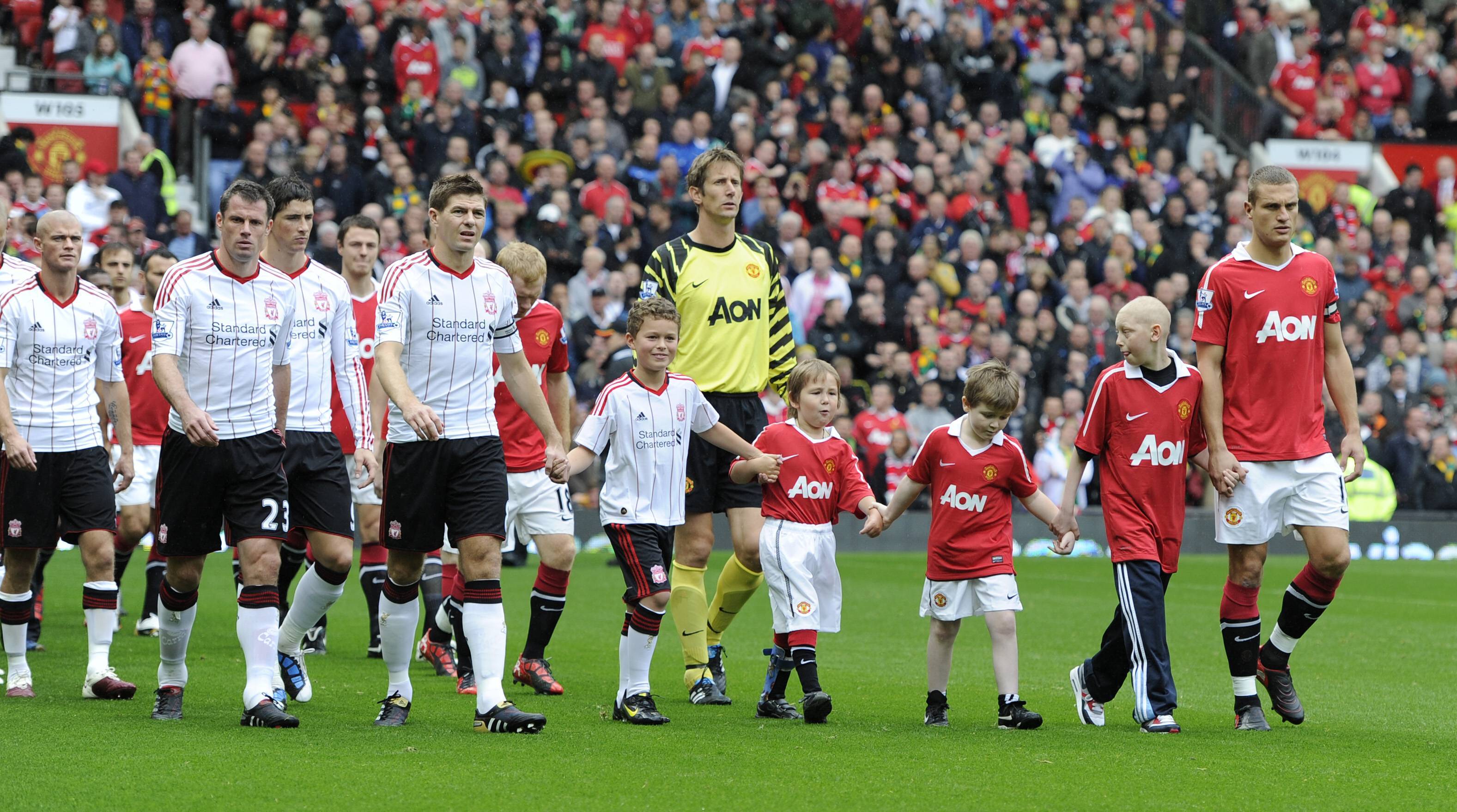 Steven Gerrard of Liverpool and Nemanja Vidic of Manchester United walk their teams out in the Premier League