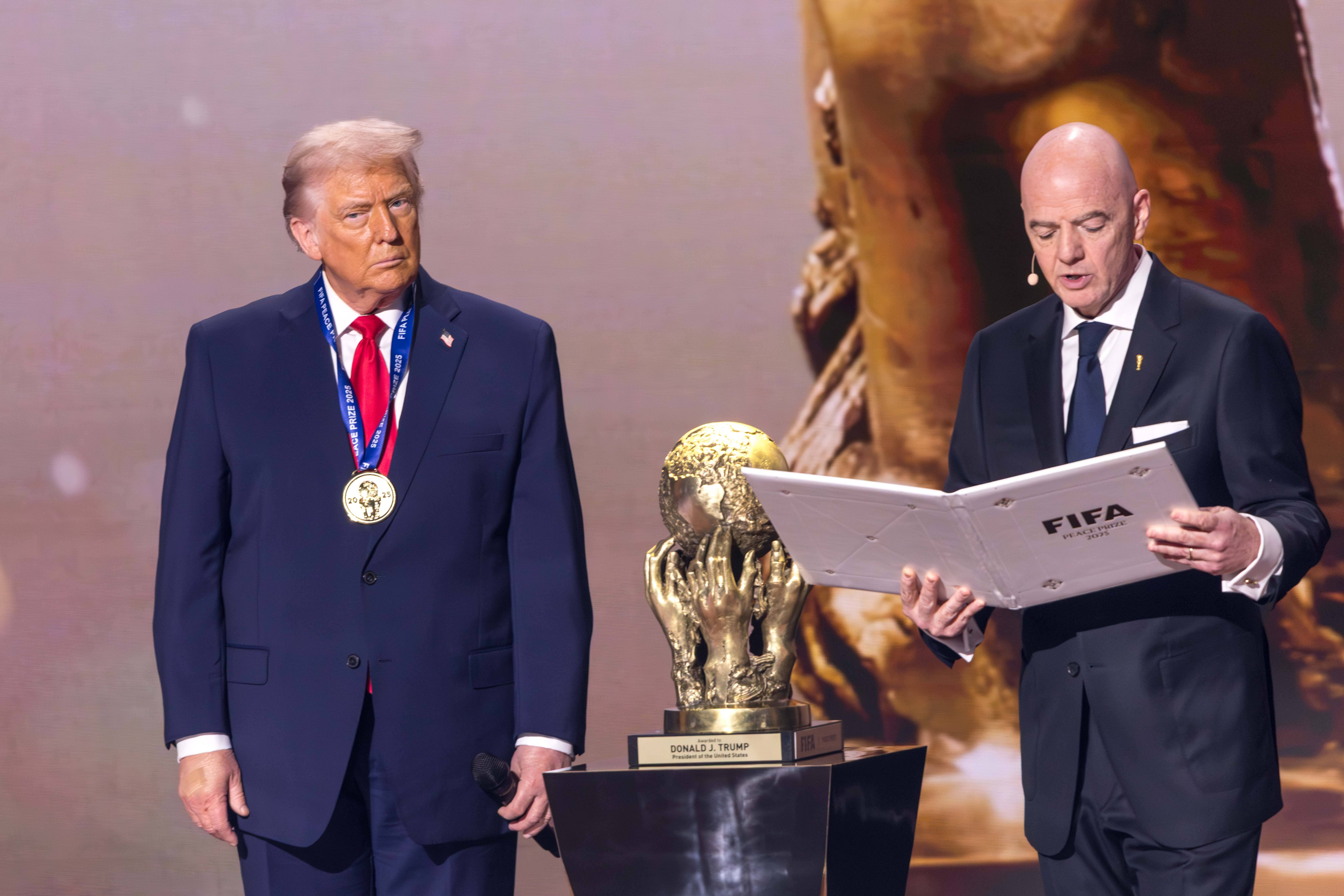 US President Donald Trump receives the FIFA Peace Prize from FIFA President Gianni Infantino at the official draw for the 2026 World Cup