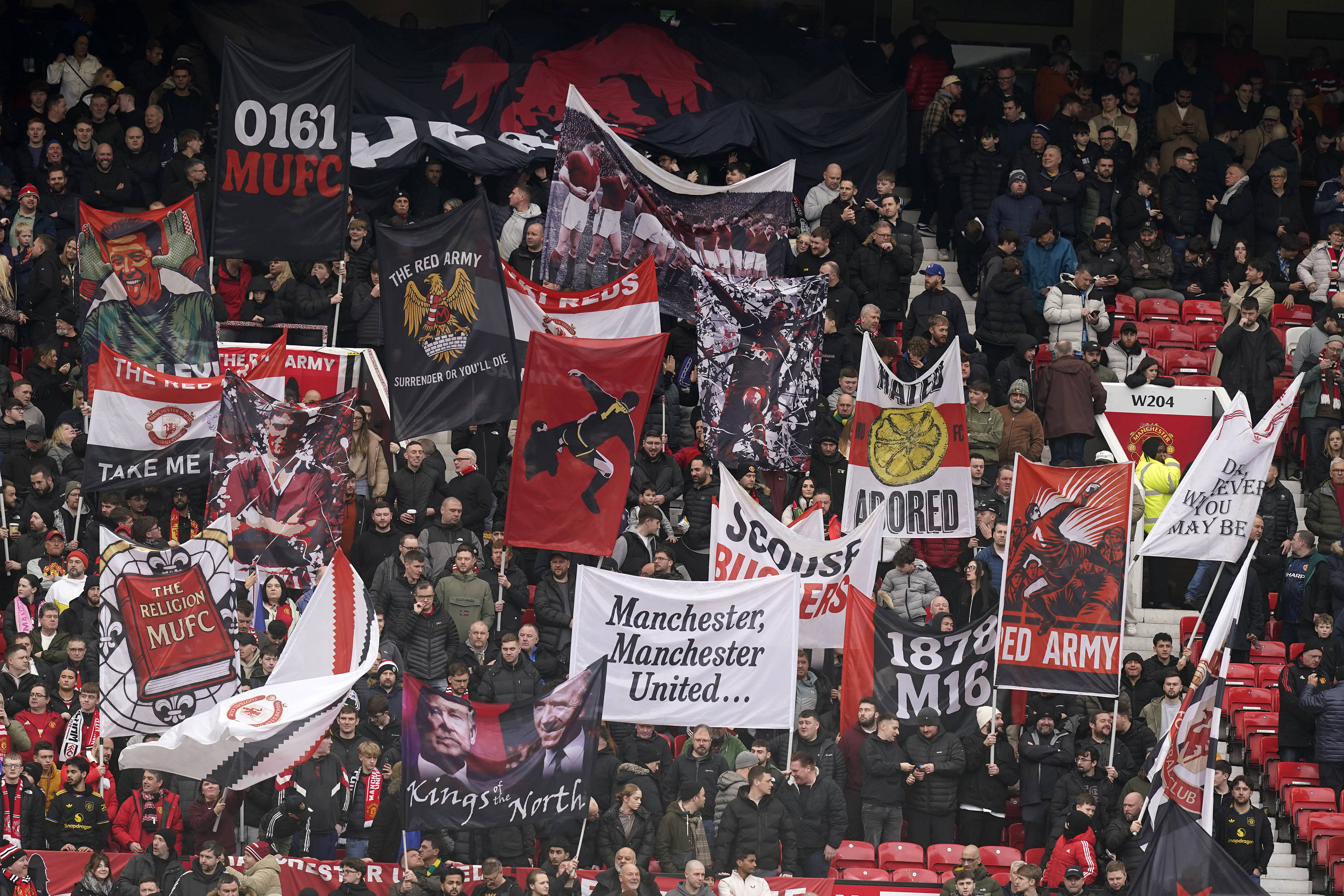 Man Utd fans hold flags at Old Trafford 