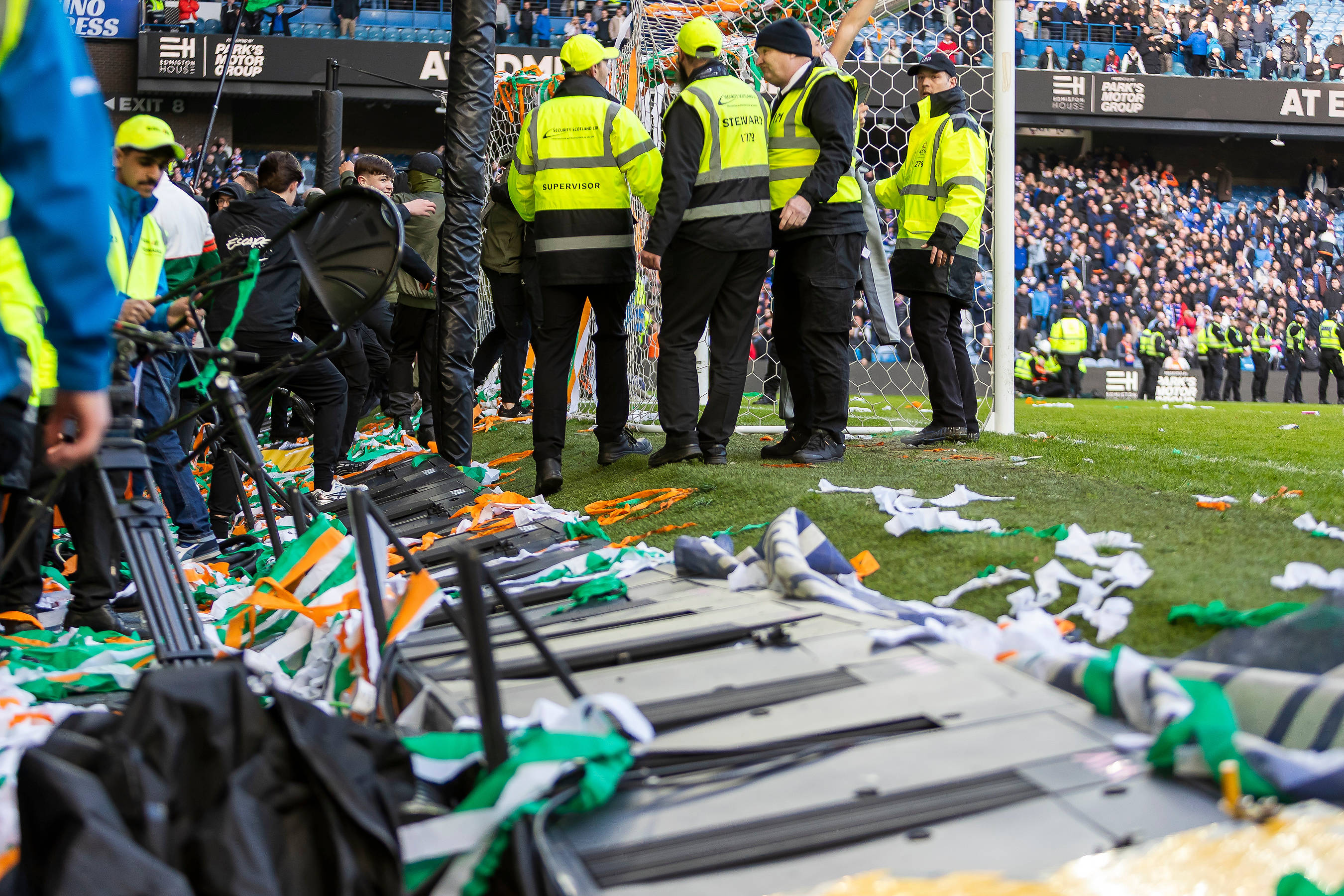 Digital advertising boards trampled down as fans broke onto the pitch following the final whistle